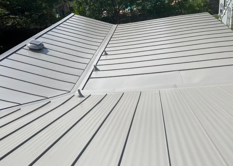 Solar attic fan installed on a metal roof for Roof Ventilation in Warren